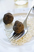 Black truffles (Chinese truffles) and risotto rice on plate