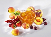 Apricot jam surrounded by fresh fruit