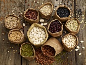 Various types of dried beans in paper bags