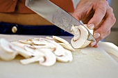Slicing button mushrooms
