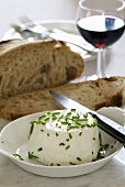 Fresh goat's cheese with bread and wine
