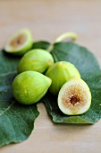 Fresh green figs on a fig leaf