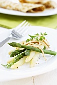 White and green asparagus with strips of pancake