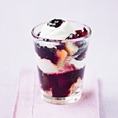Layered yoghurt and plum dessert in a glass