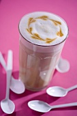 A glass of cafe latte with pattern in milk foam
