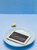 Slate board with the word Calcium on blue plate