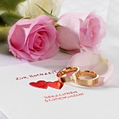 Wedding card, wedding rings and roses