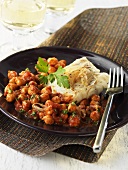 Fish fillet on chick-peas and tomatoes