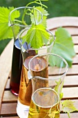 White wine & red wine in carafes on wooden table out of doors