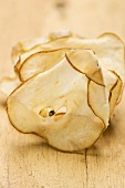 Dried pear slices on a wooden background