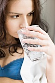 Young woman drinking a glass of mineral water