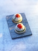 Two cucumber, cherry tomato and mayonnaise canapés
