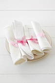 Fabric napkins with ribbons on plates