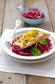 Salmon trout with lemon and mint on red onions