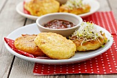 Small cheese pancakes with sprouts and tomato dip