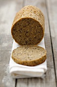 A round loaf of spelt bread, partly sliced