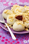 Potato dumplings with plum filling and buttered almonds