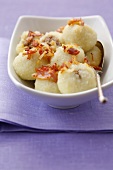 Potato dumplings with meat filling and fried bacon