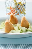 Breaded fish pieces with cucumber