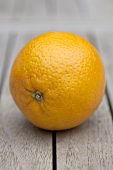An orange on a wooden table