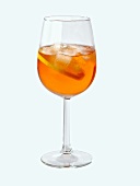 A glass of Aperol with ice cubes and slice of lemon