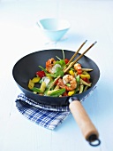 Prawns and vegetables in wok