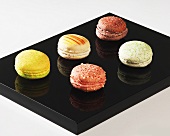 Five different coloured macarons (small French cakes)