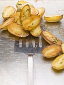 Roasted potatoes with rosemary on baking tray
