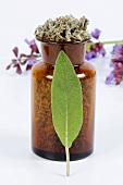Dried sage in an apothecary bottle