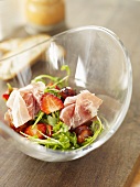 Rocket salad with strawberries and ham