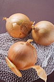 Three onions on a net bag