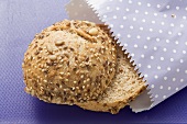 Wholemeal roll in paper bag