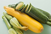 Green and yellow courgettes with courgette flowers