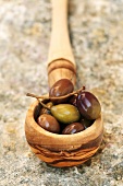 Olives in wooden spoon (close-up)