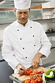 Chef slicing tomatoes