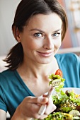 Woman eating salad