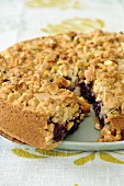 Crumble cake with flaked almonds, a piece cut