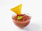 Taco chip in tomato dip