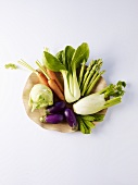 Assorted vegetables on a wooden plate
