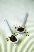 Dried tea leaves in two spoons