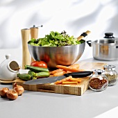 Salad ingredients & seasonings with chopping board & knife