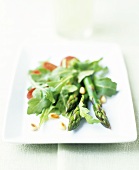 Asparagus salad with rocket, pine nuts and chorizo