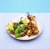 Grilled chicken kebabs with salad