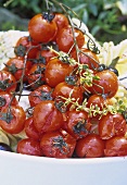 Baked cherry tomatoes on plate of pasta