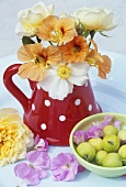 Flowers in jug and a bowl of wild apples
