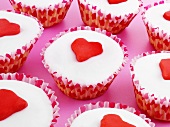 Several cupcakes decorated with marzipan hearts