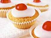 Iced cupcakes with cherries
