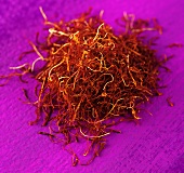 Saffron threads on purple background