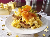 Bagel topped with scrambled egg and smoked salmon