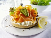 Bagel topped with cream cheese, smoked salmon and gherkin